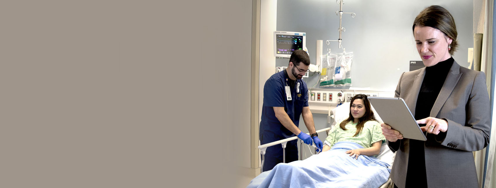 Specialist conducting inspection in hospital room with nurse and patient