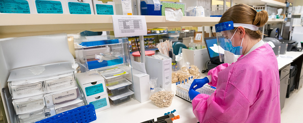 Lab technician sorting various chemicals and containers