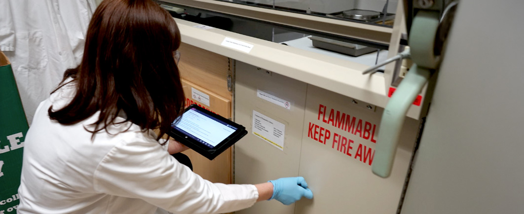 EHS specialist looking into a flammable safe cabinet