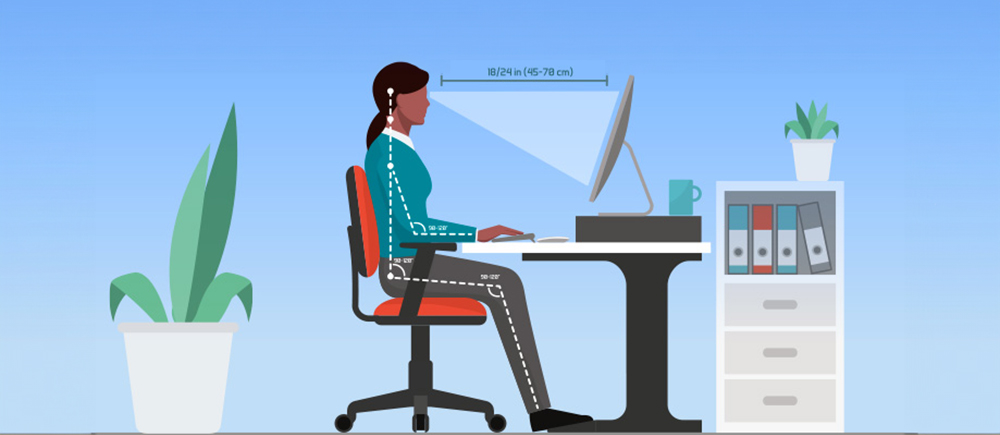 An individual sitting ergonomically at a work desk, facing a desktop computer, suggests a comfortable and productive workspace.