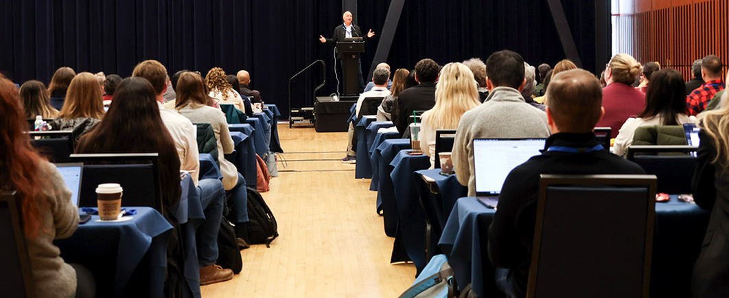 Speaker addressing a room of people about Risk and Safety Solutions products