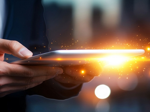 Person holding a tablet with illuminated information 